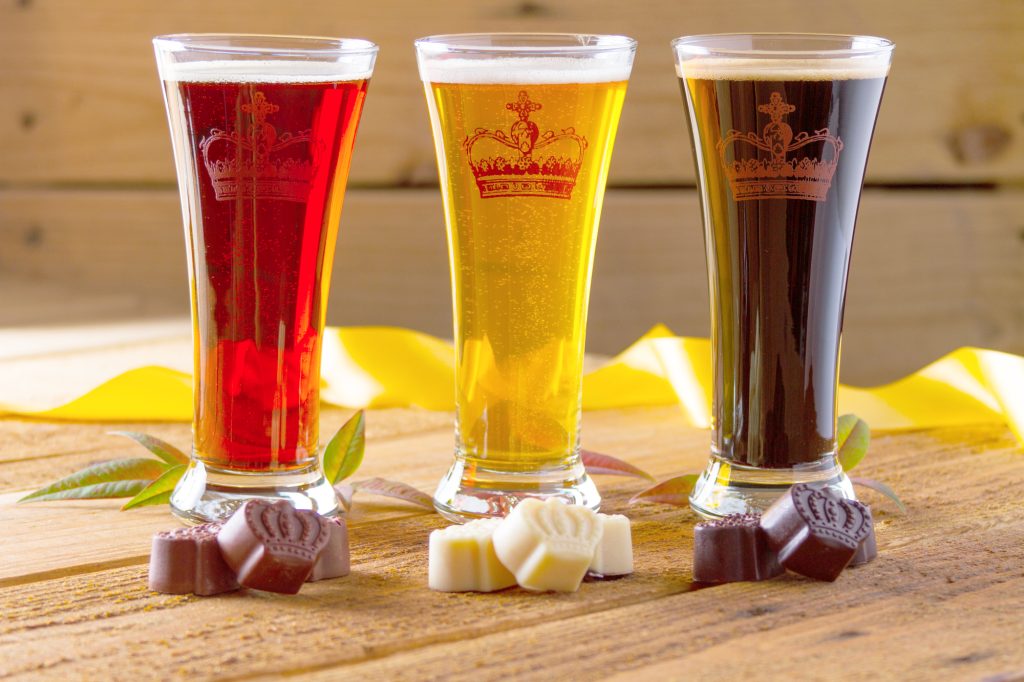 Glasses of amber, pale, and dark beers paired with milk chocolate, dark chocolate, and white chocolate