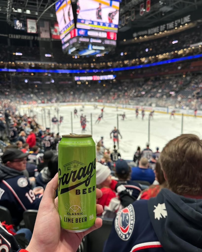 A tall boy of garage beer lime at a hockey game