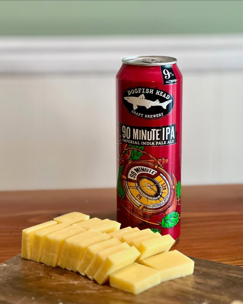 Stovepipe can of 90-minute IPA next to a plate of cheese.
