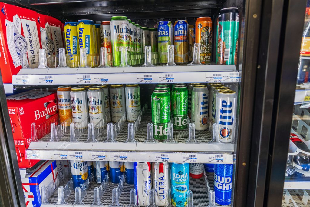 Store refrigerator full of tall boy beers