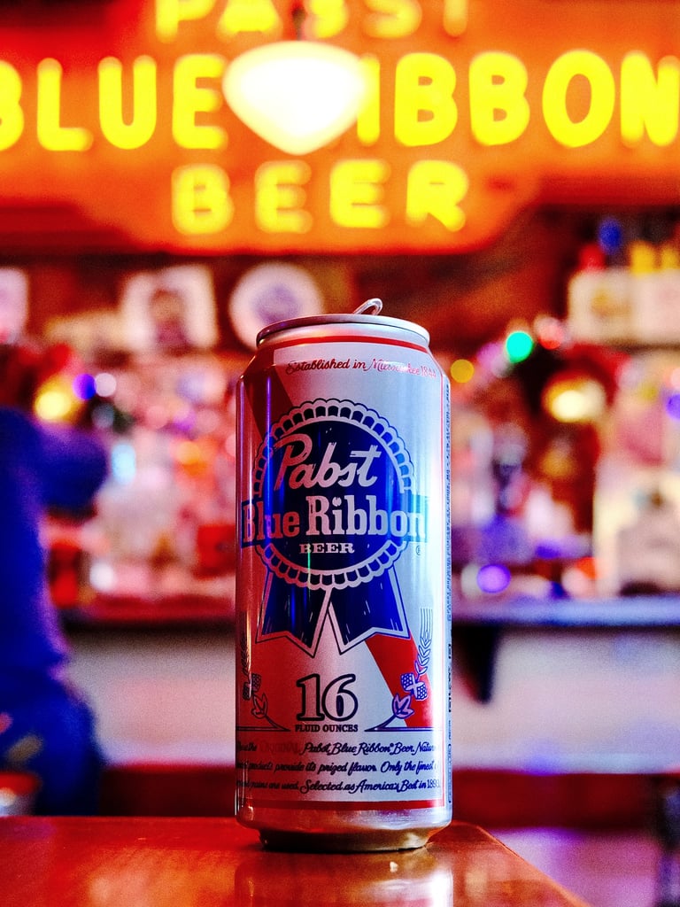 A tall boy of Pabst Blue Ribbon in a warmly lit bar