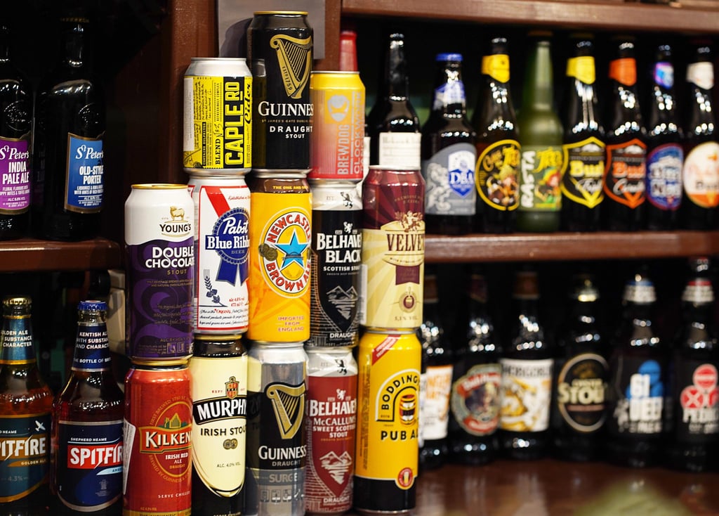 A large assortment of Irish beer cans, includng Guinness Irish Beer, Murphy's Irish Beer, and Kilkenny Irish Beer