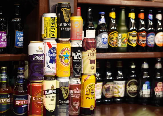A large assortment of Irish beer cans, includng Guinness Irish Beer, Murphy's Irish Beer, and Kilkenny Irish Beer