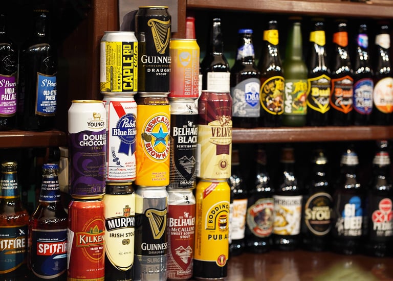 A large assortment of Irish beer cans, includng Guinness Irish Beer, Murphy's Irish Beer, and Kilkenny Irish Beer